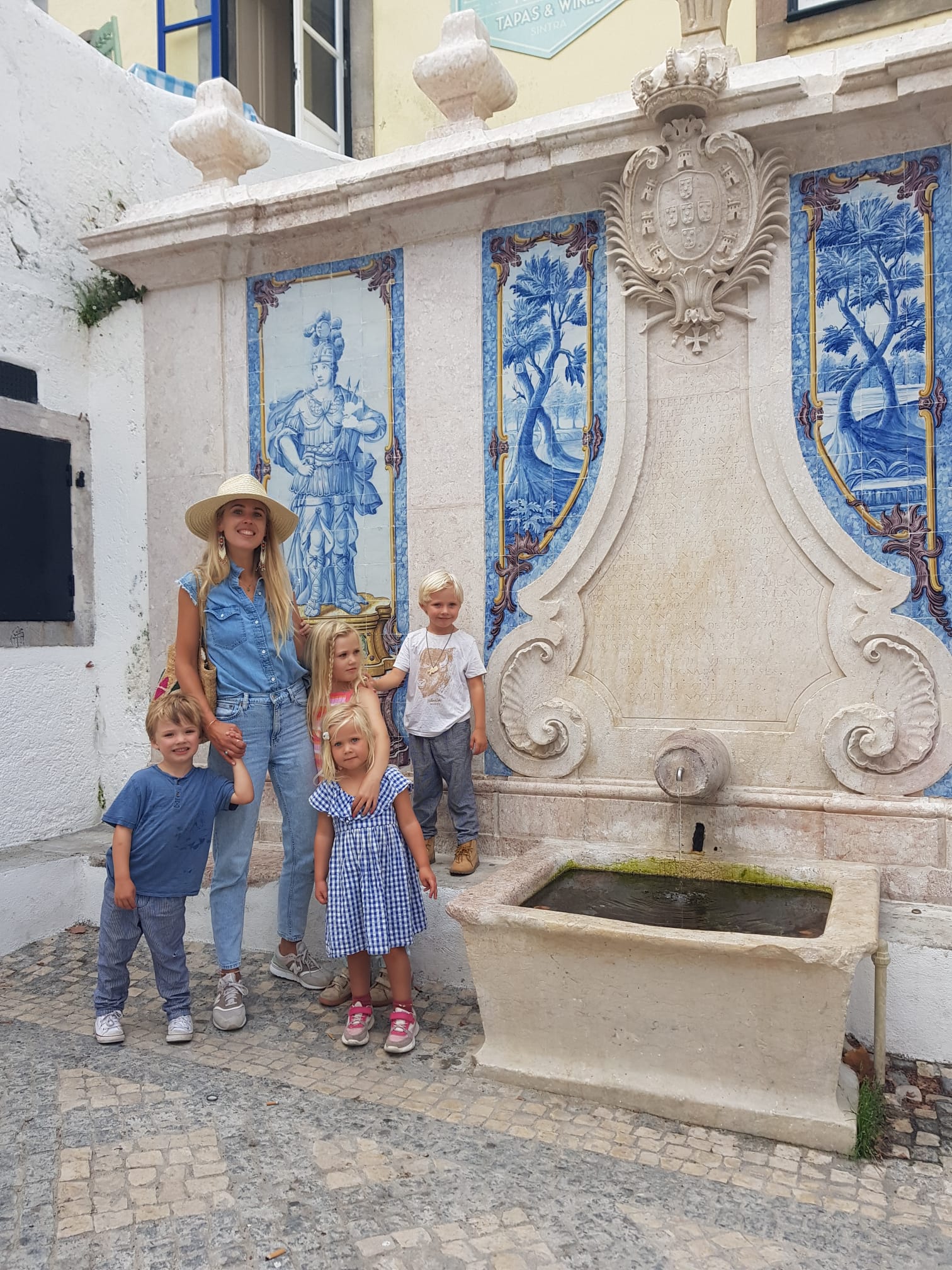 Jessica and her four children in front of beautiful Portuguese azulejo tiles